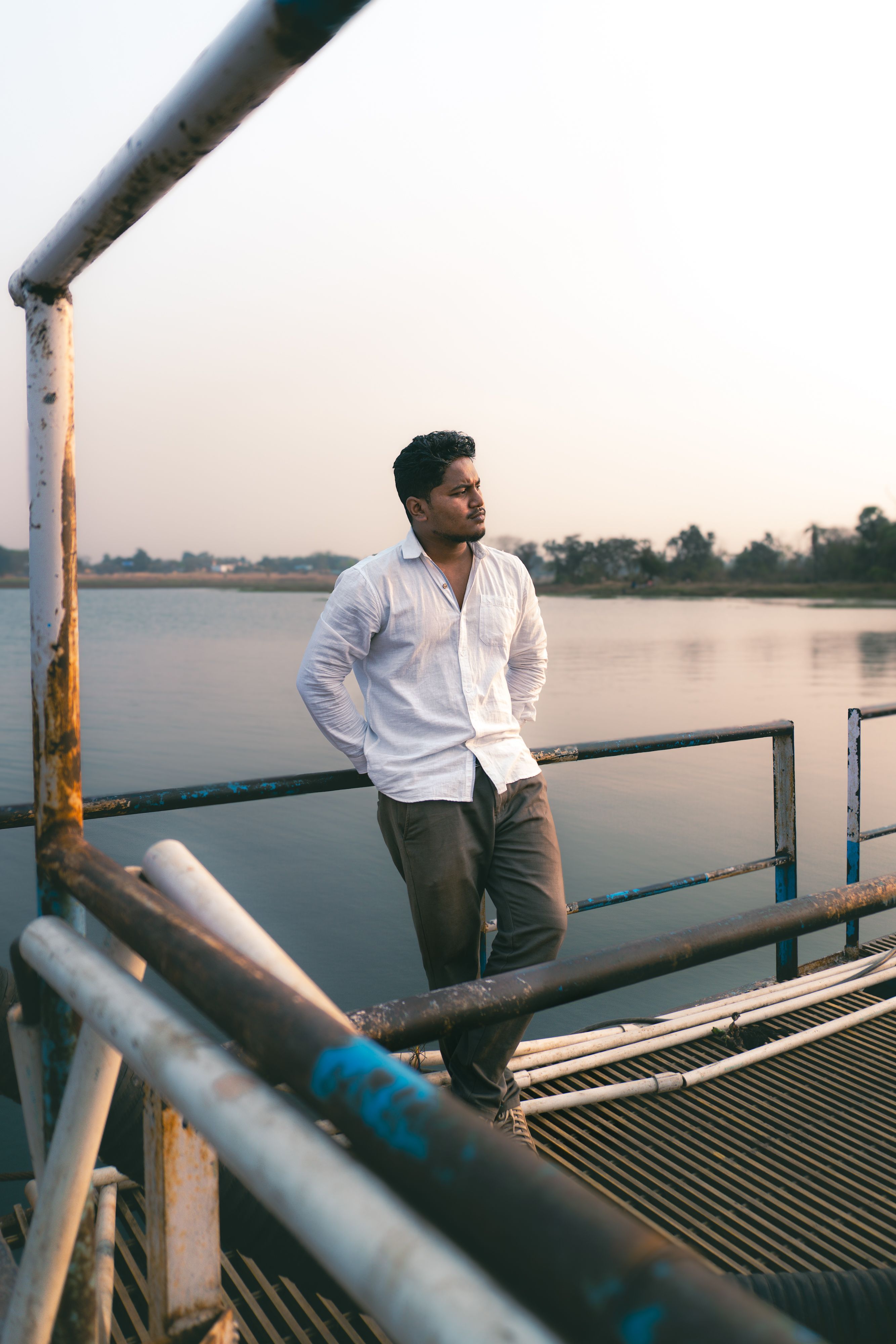 Contemplative Man by a Tranquil Lake at Sunset · Free Stock Photo