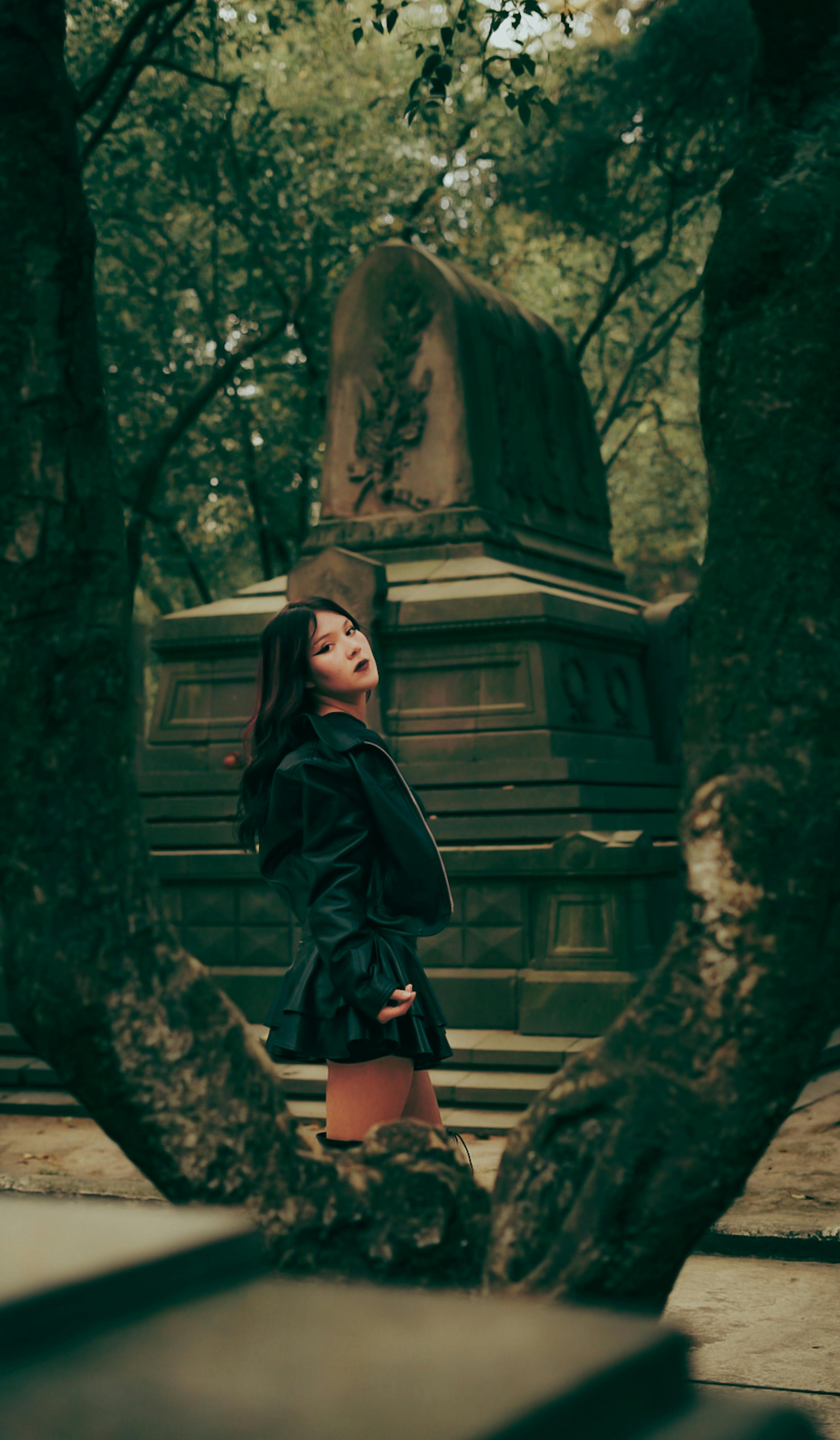 Portrait of Woman in Forested Cemetery Setting