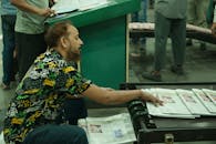 Worker at Printing Press Sorting Newspapers