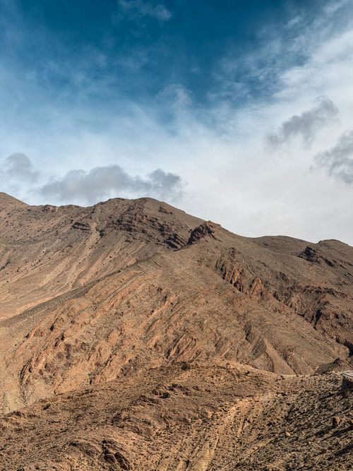 Free A breathtaking view of rocky mountains under a partly cloudy sky in Fès-Meknès, Morocco. Stock Photo