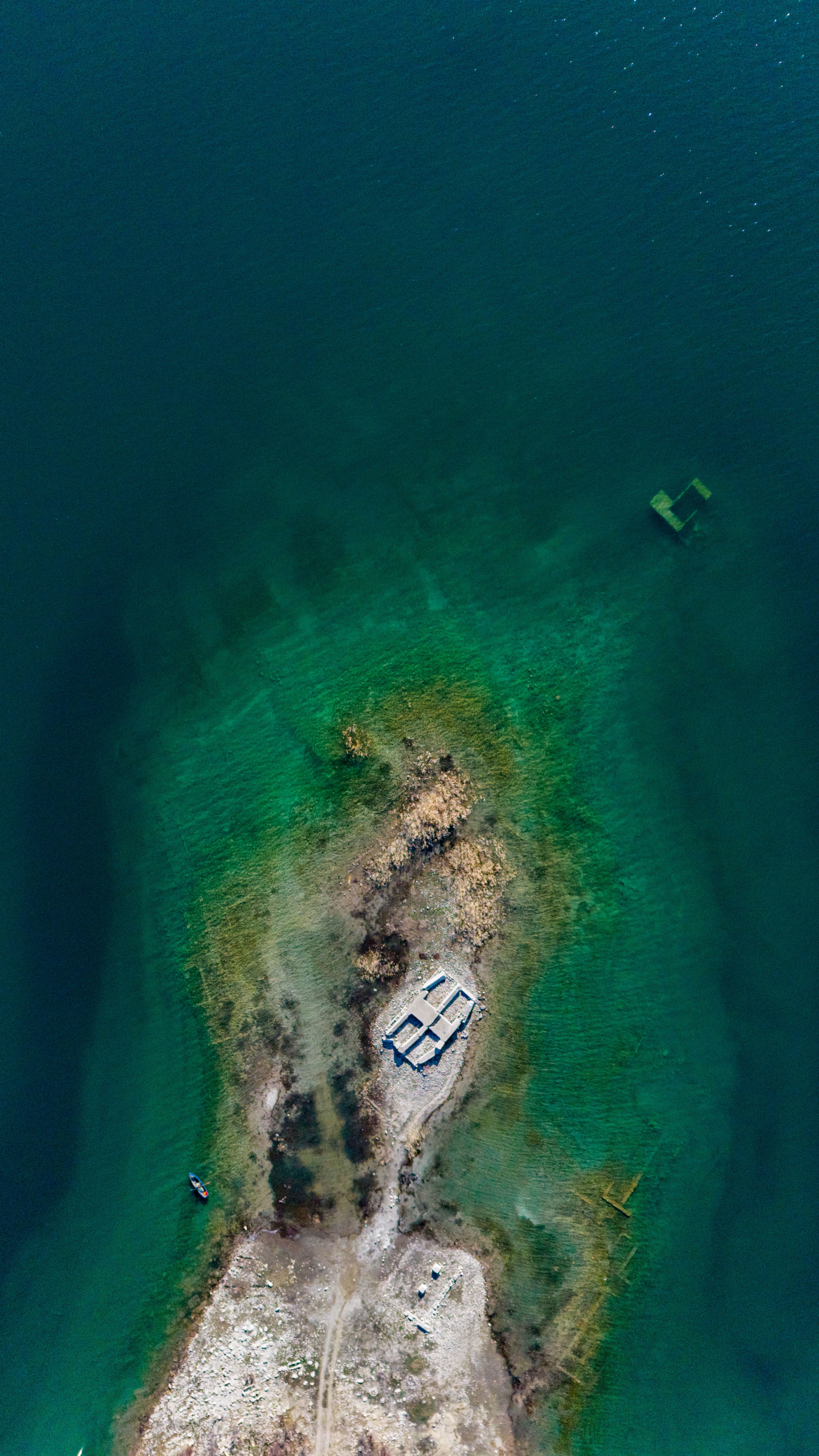 Aerial View of Rocky Island in Turquoise Waters · Free Stock Photo