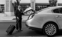 Professional Chauffeur Loading Luggage into Sedan