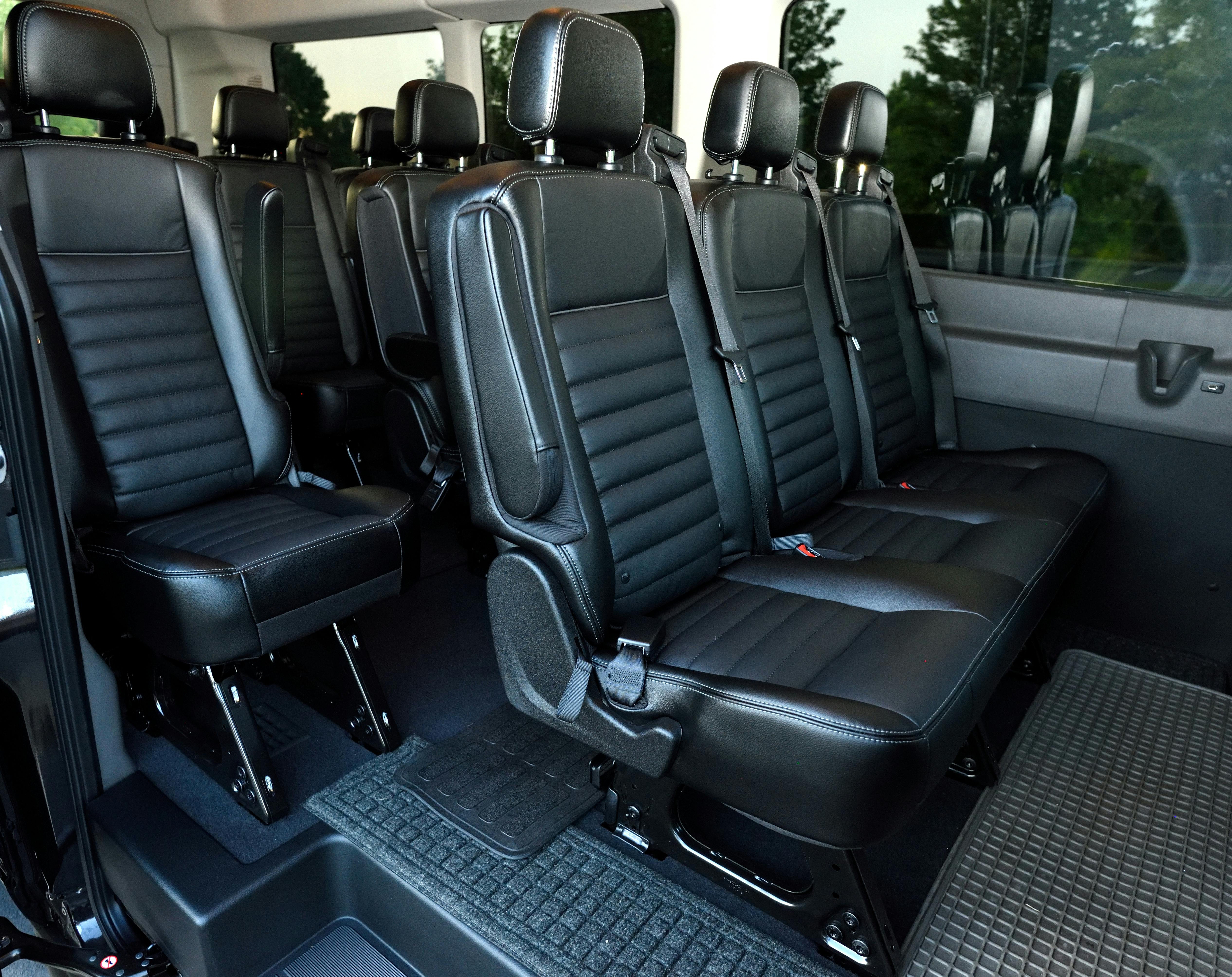 Interior of a luxury minivan with bottled water and clean seats - private airport transfer
