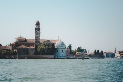 A serene view of San Michele, Venice's famous cemetery island, surrounded by calm waters and historic architecture.
