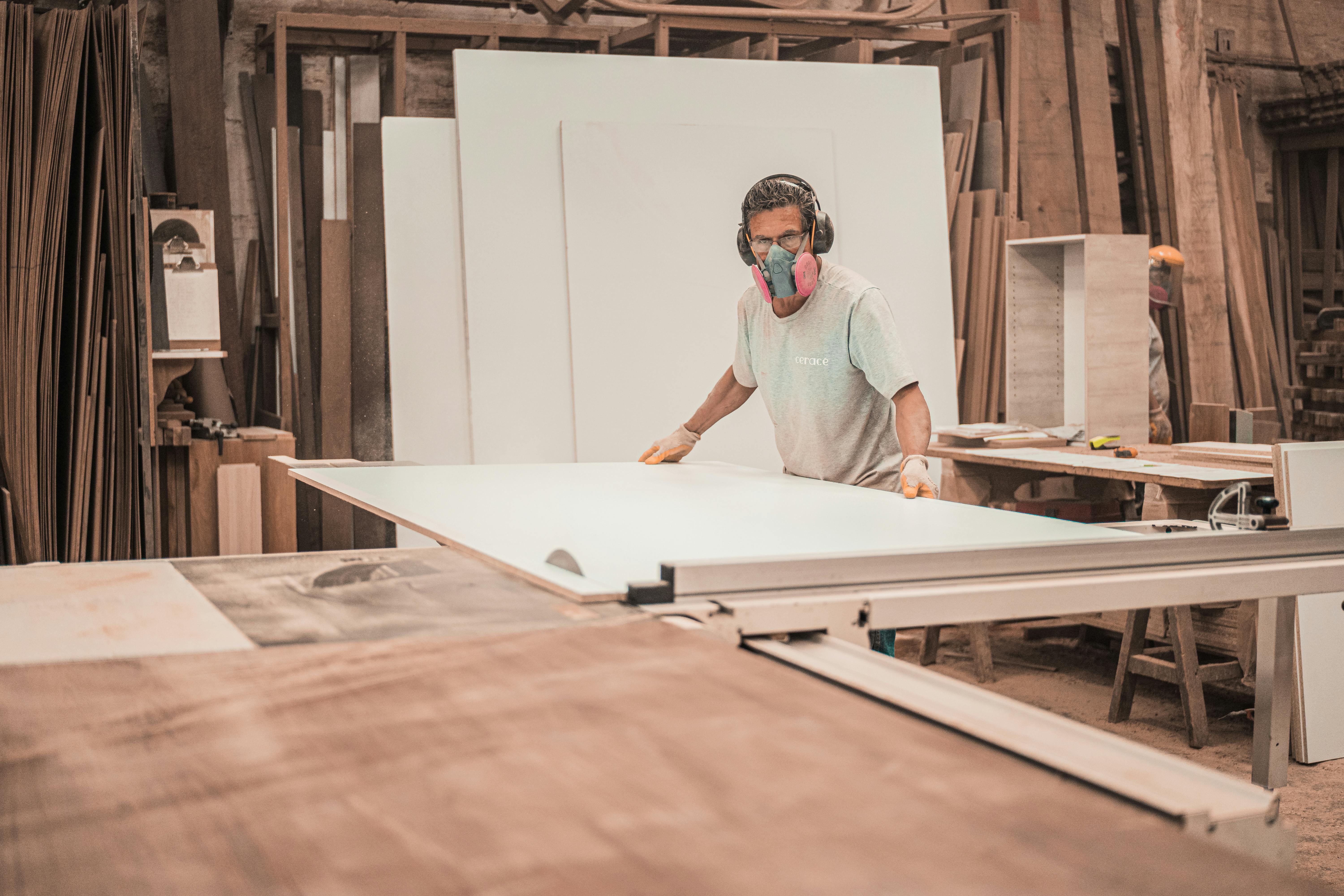 Man working on a wooden board. | Photo: Pexels