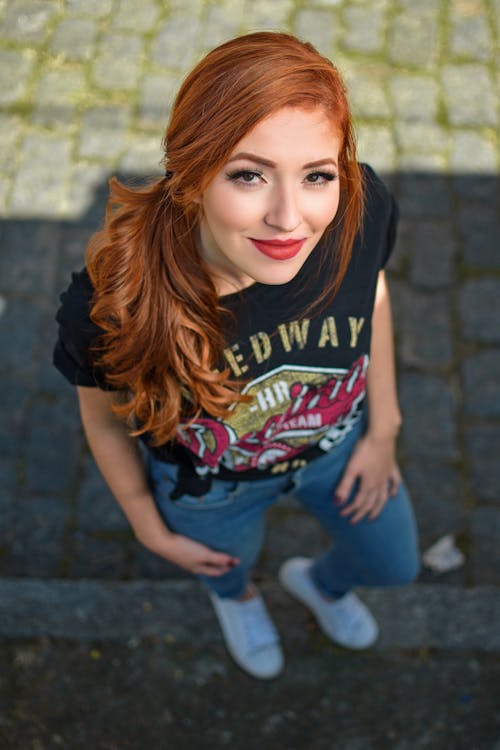 Woman in Black T-shirt and Blue Denim Jeans