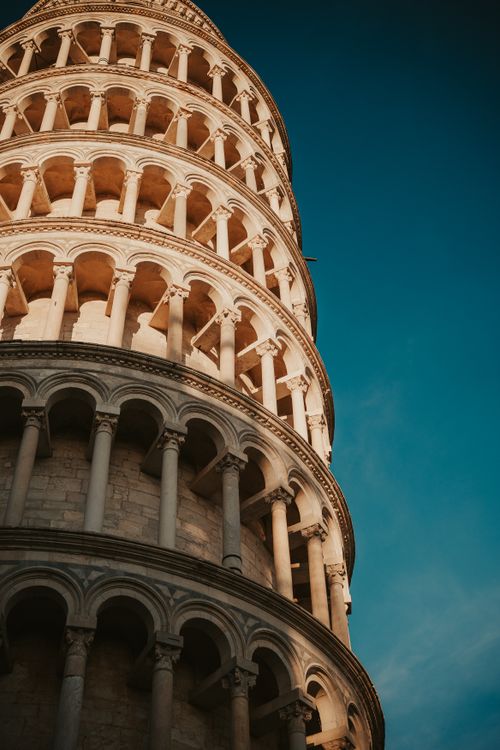 Free Close-up of the Leaning Tower of Pisa against a clear evening sky, showcasing its unique architecture. Stock Photo