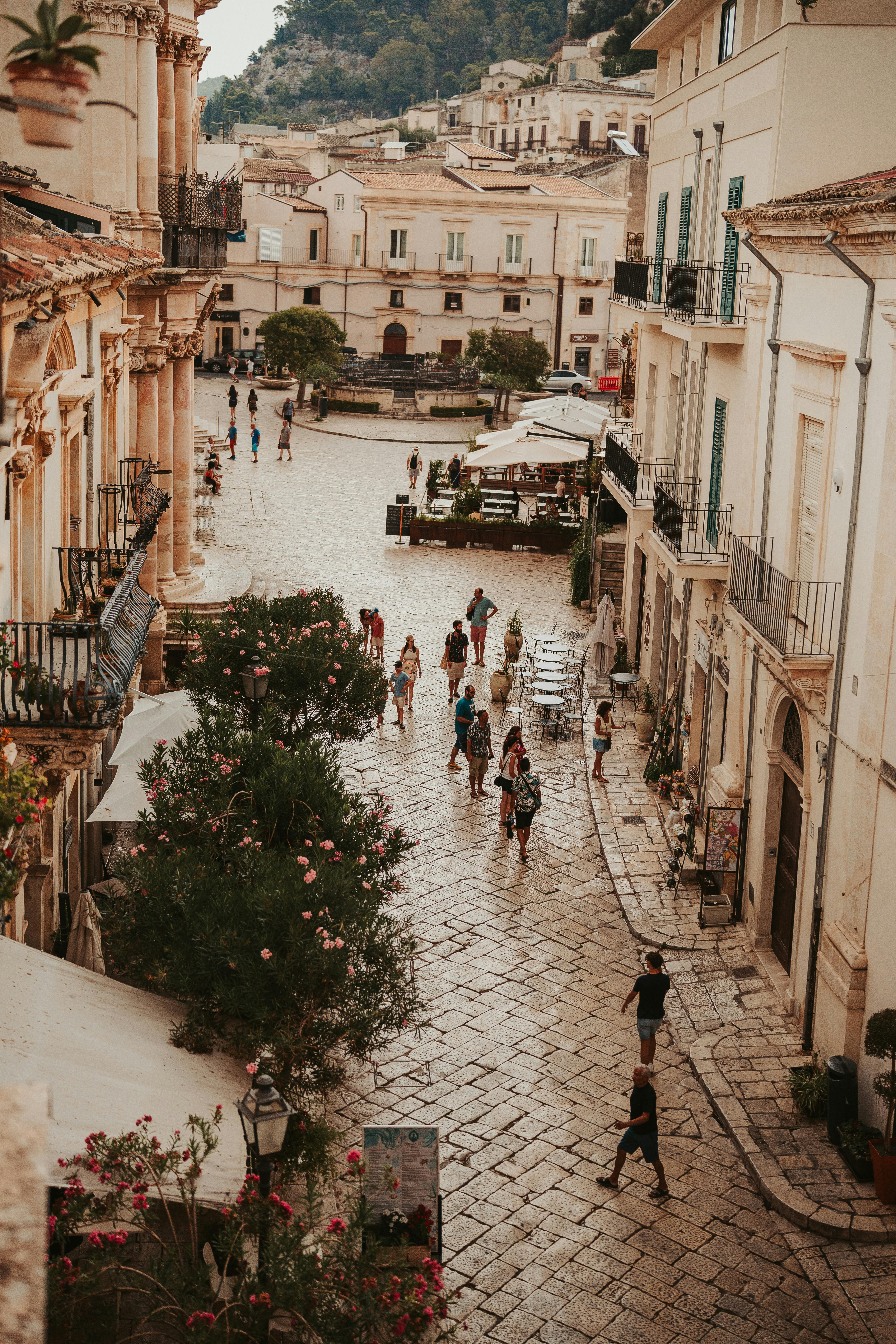 Gratis Pemandangan udara sebuah alun-alun Eropa yang ramai dengan jalanan berbatu, yang menangkap esensi kehidupan lokal. Foto Stok