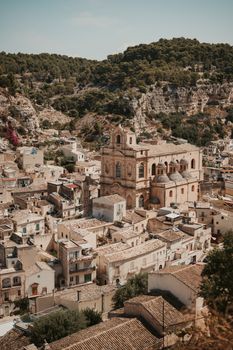 Aerial view of Modica, Sicily showcasing historic architecture and rugged landscape.