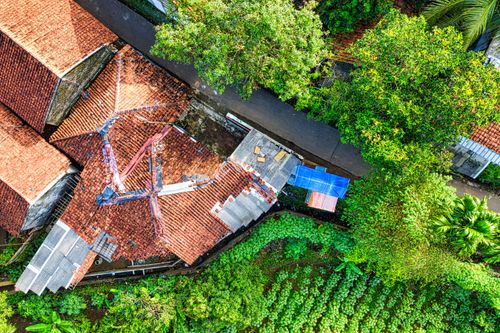 Free A vibrant aerial shot showcasing rustic houses and lush greenery in West Java, Indonesia. Stock Photo