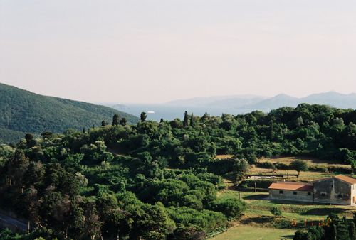 Free Lush green hills and a distant view create a serene countryside scene. Stock Photo