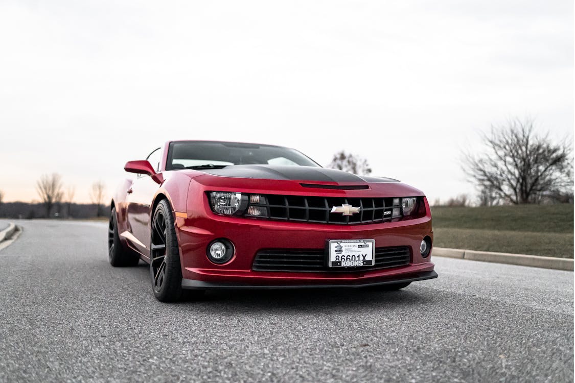 Red Chevrolet parked on the road