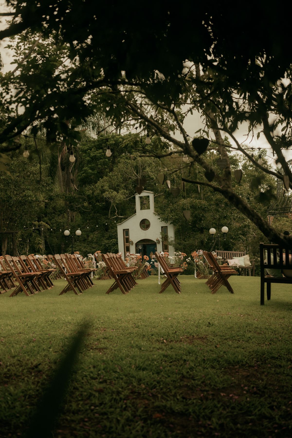 Rustic venue with wooden seating and a chapel