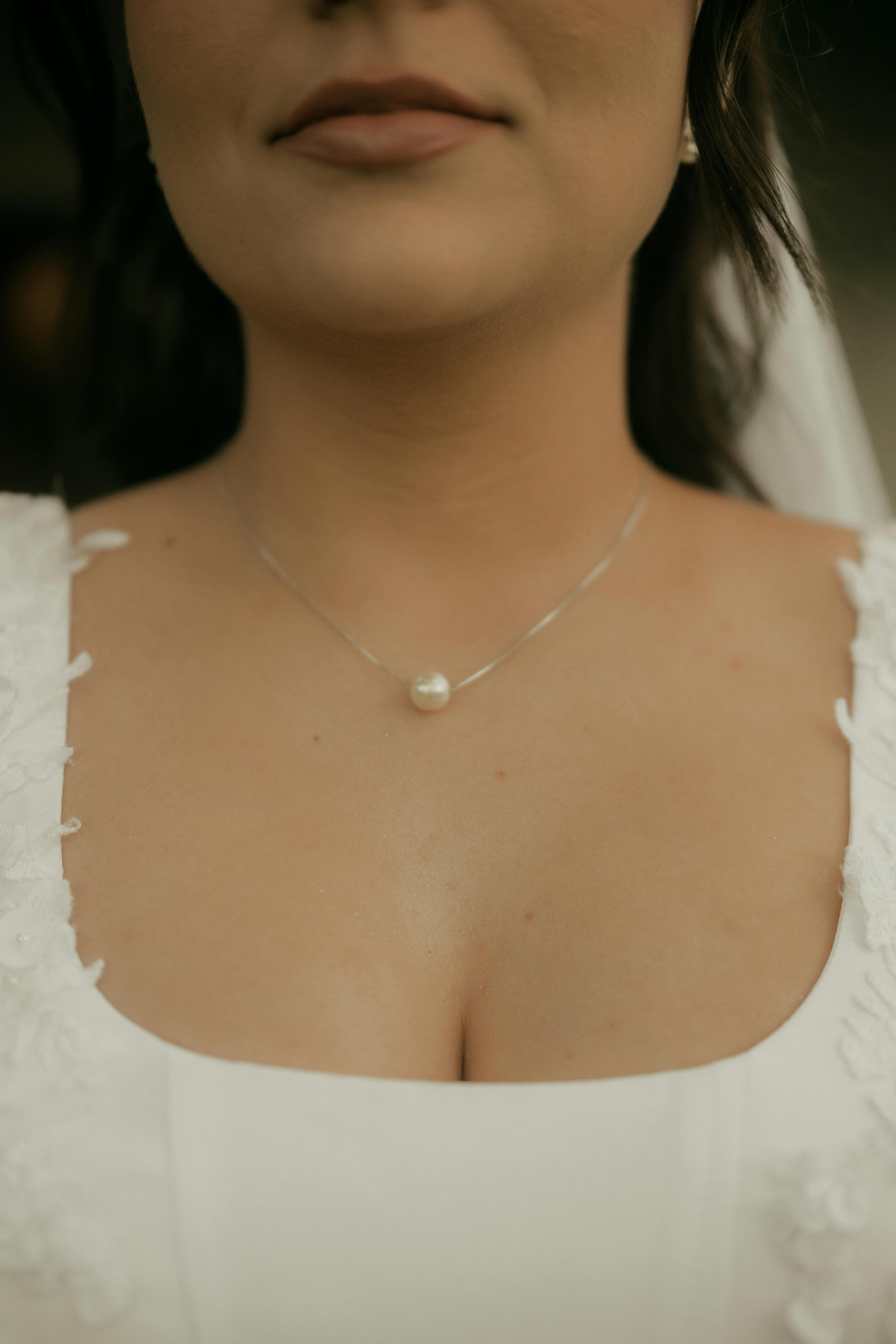 Free Close-up of a bride wearing a pearl necklace on her wedding day. Stock Photo
