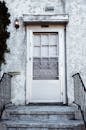 Black Metal Fence Near White Wooden Door