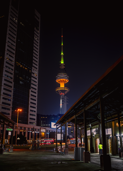 Stunning night view of Liberation Tower in Kuwait City showcasing modern architecture and vibrant lights.