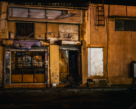 Vintage storefront in Kuwait City at night showcasing traditional architecture.