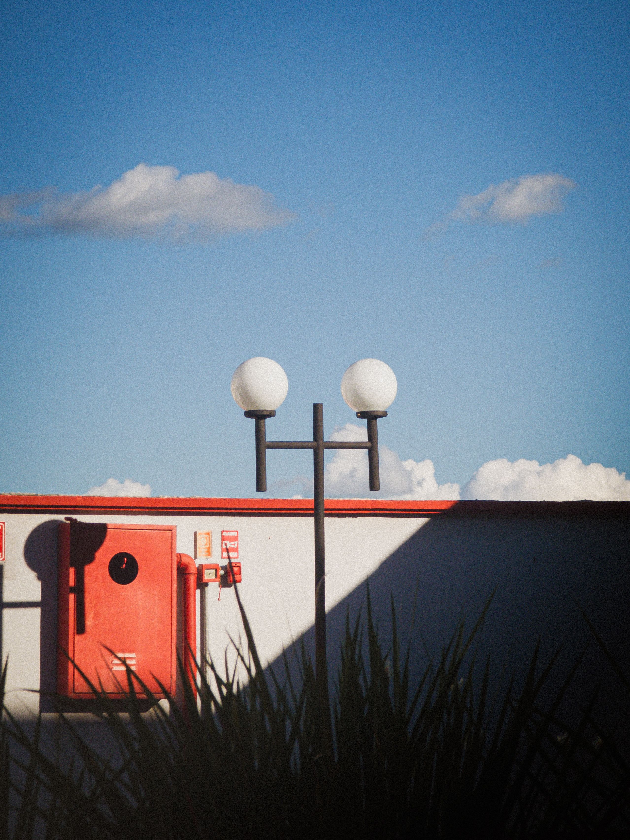 Urban Rooftop with Modern Lamp Post and Blue Sky · Free Stock Photo