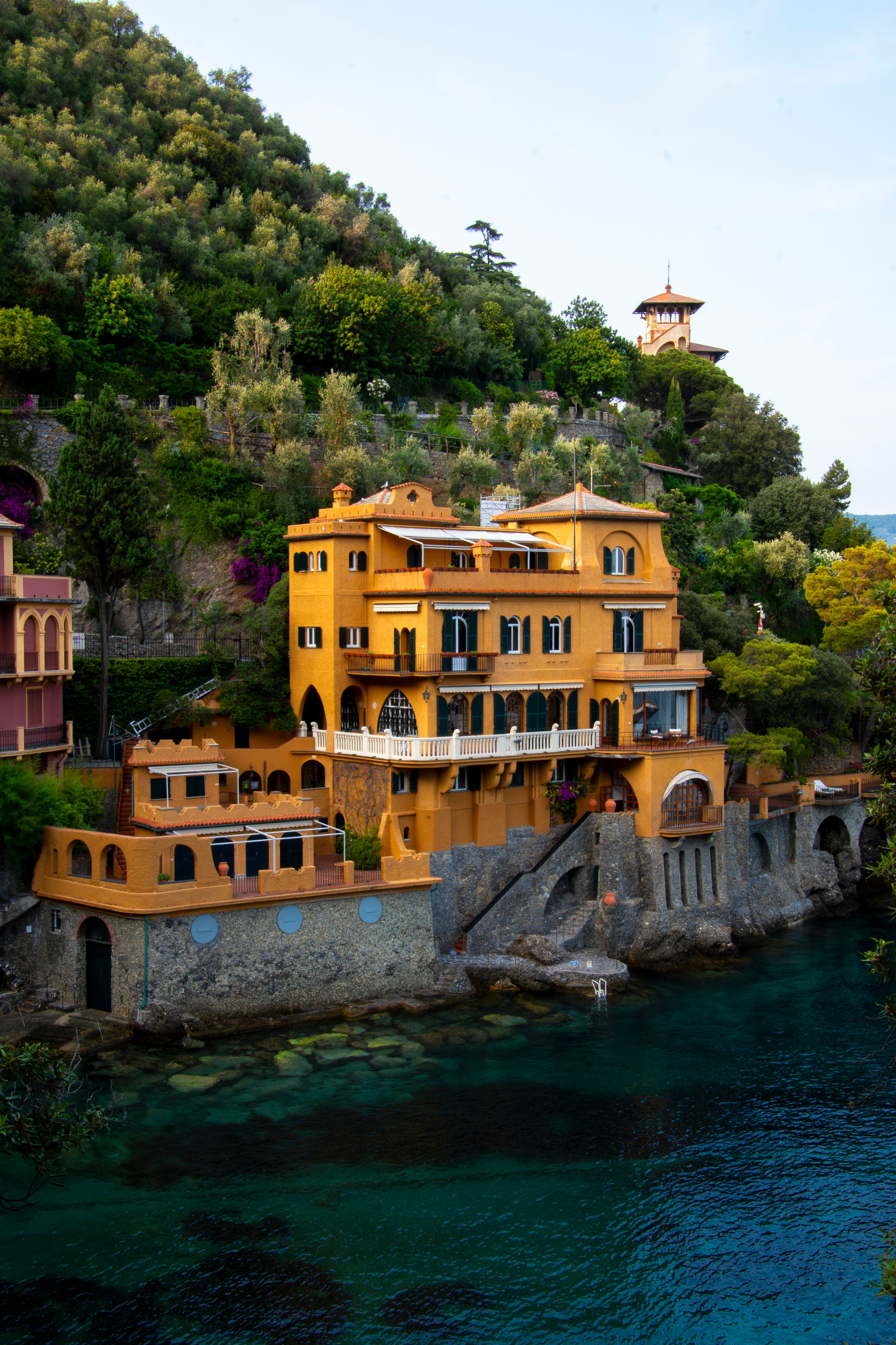 Elegant coastal villa overlooking the Ligurian Sea in Portofino, Italy, showcasing vibrant architecture and lush greenery.