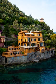 Elegant coastal villa overlooking the Ligurian Sea in Portofino, Italy, showcasing vibrant architecture and lush greenery.