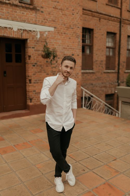 Casual Portrait of Young Man in Urban Brick Setting · Free Stock Photo