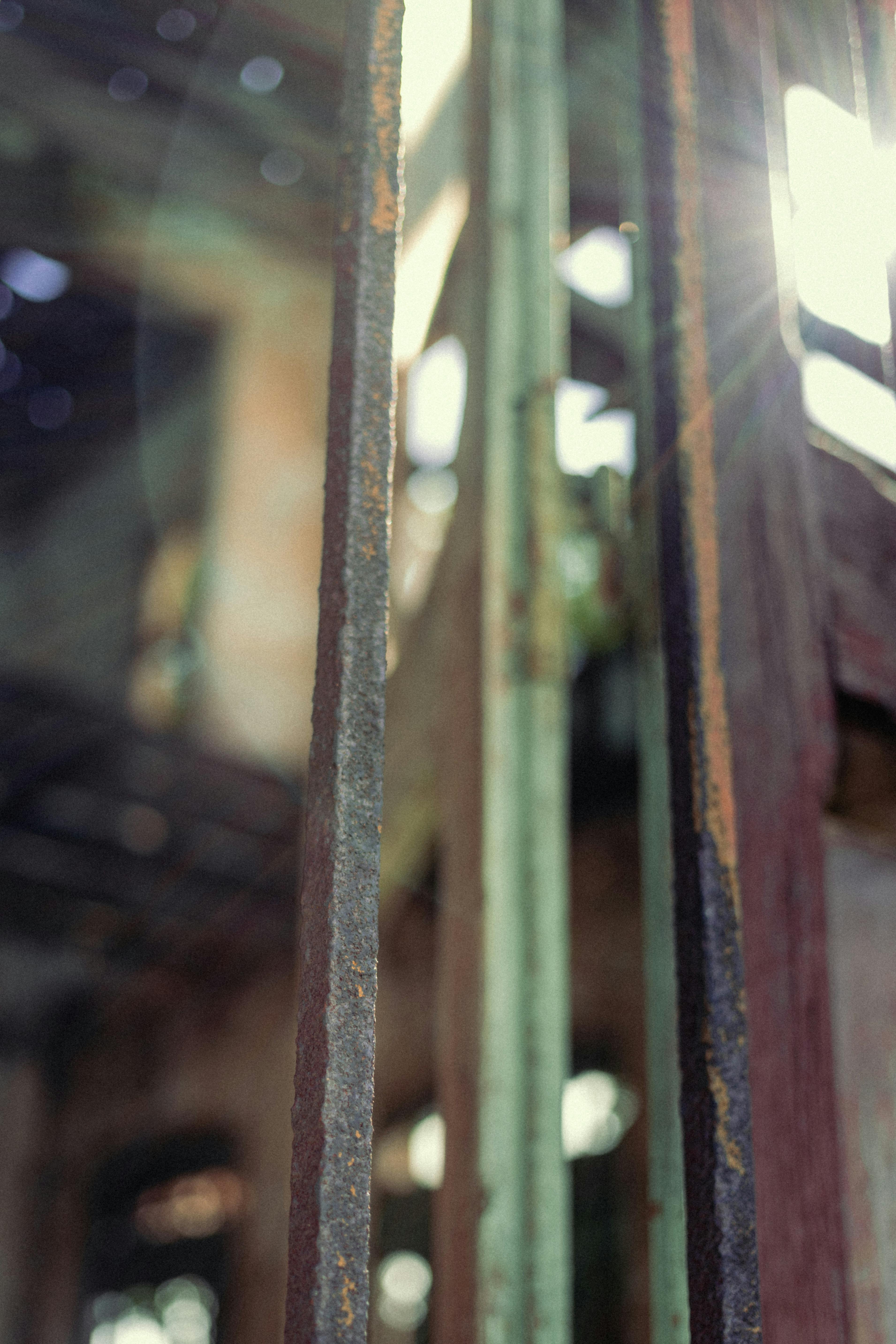 Free Rusty bars in sunlight within an old, abandoned building interior. Stock Photo