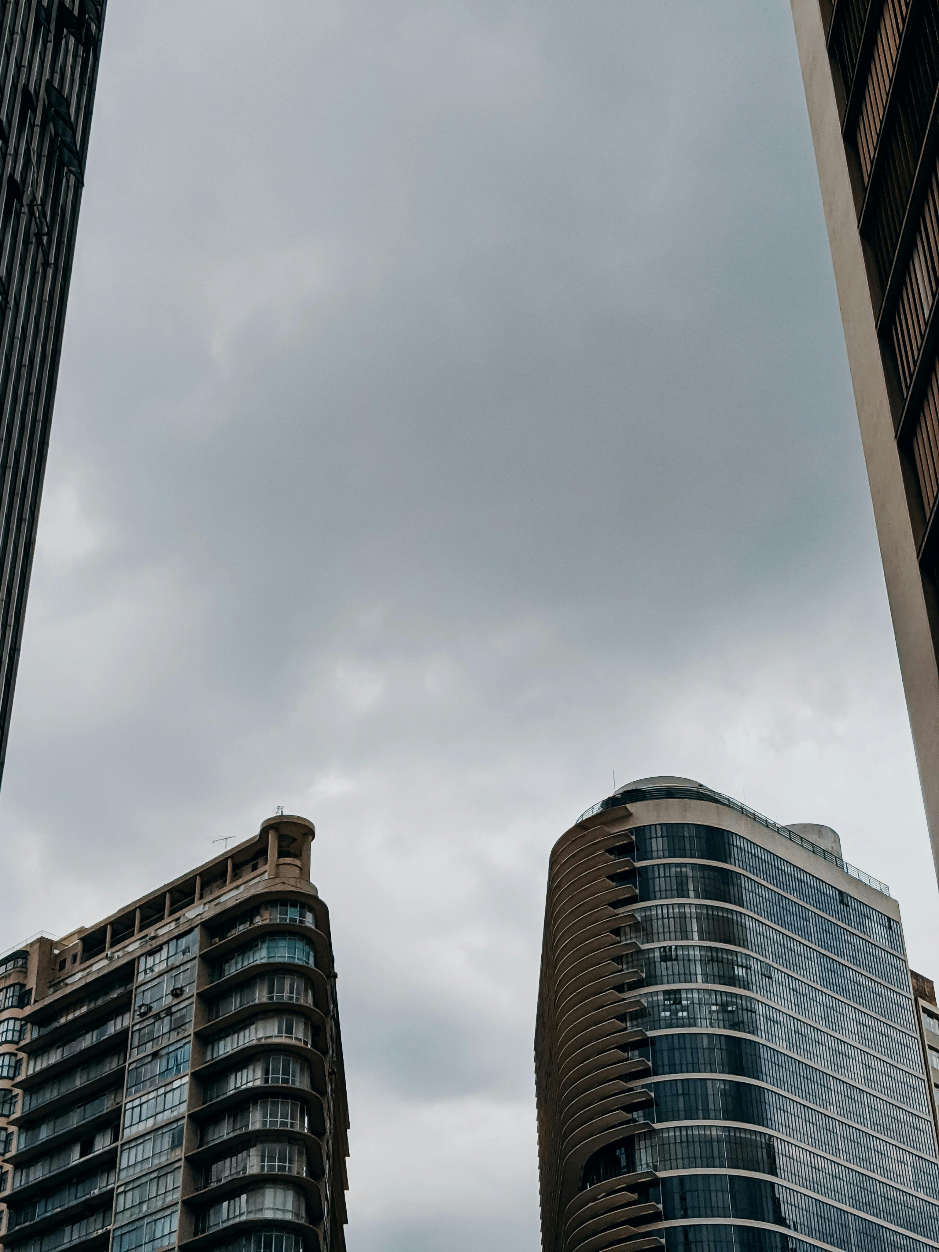 Free View of modern skyscrapers against a cloudy sky in Belo Horizonte, Brazil, showcasing urban architecture. Stock Photo