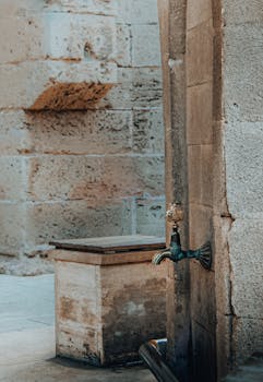 A rustic water spout on an aged stone wall capturing old-world charm in Gazimağusa.