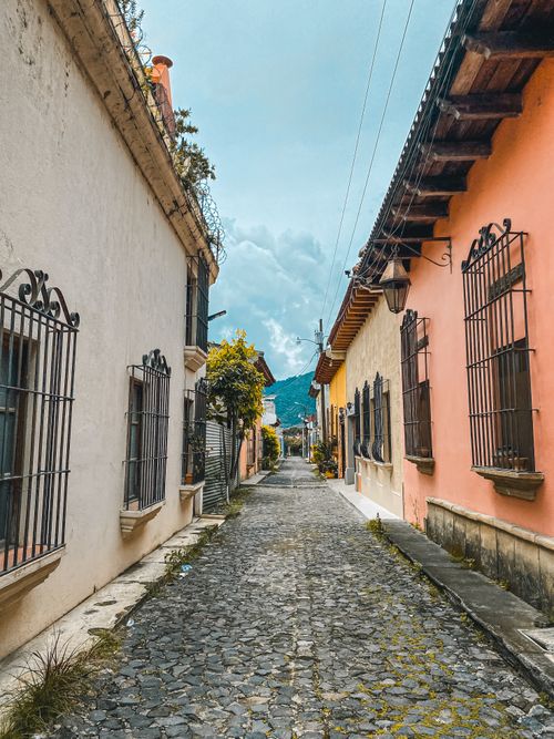 Free Scenic view of colorful colonial buildings on a cobblestone street in Antigua Guatemala. Stock Photo