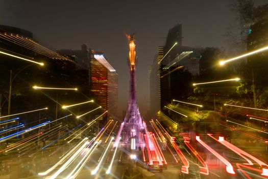 Dynamic night view of Angel of Independence with motion blur in Mexico City.