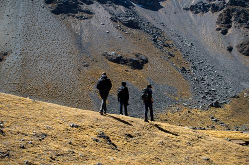 Free Three hikers traverse a rugged mountain path in the Andes, Cusco, Peru. Stock Photo