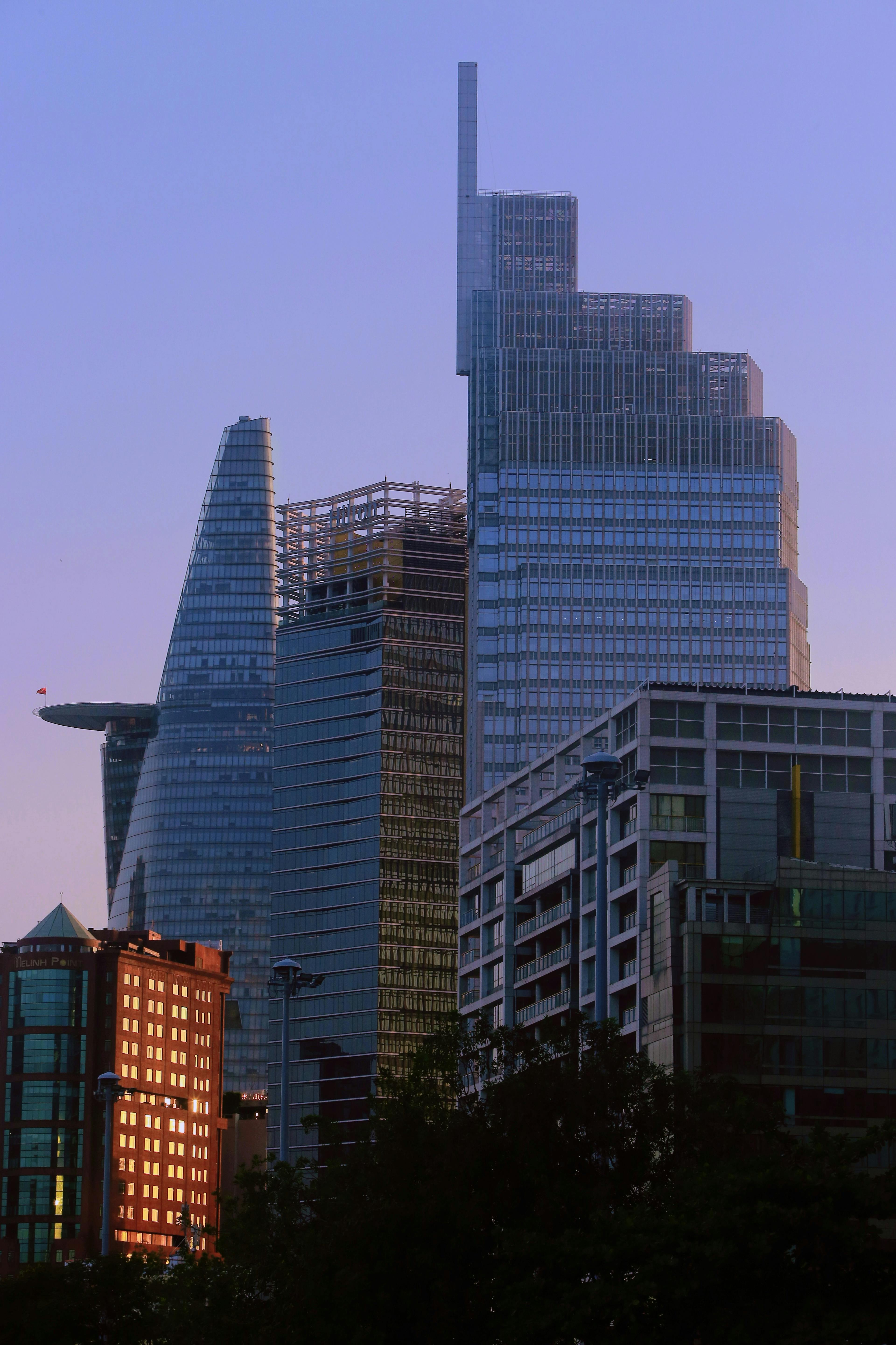 Free A skyline view of modern skyscrapers at sunset with elegant architecture. Stock Photo
