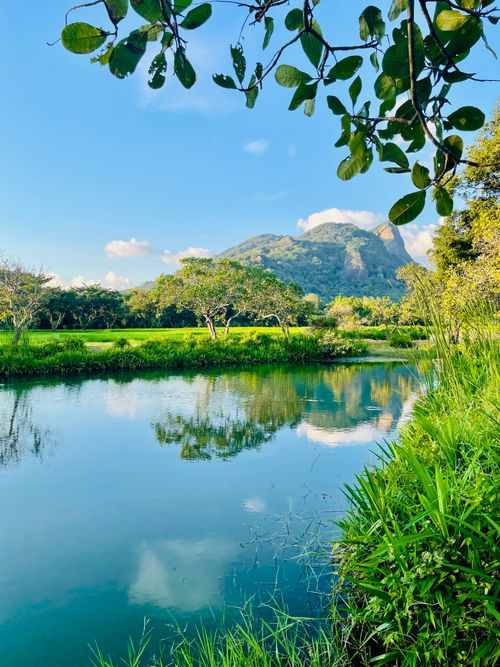 Free A tranquil scene showcasing a mountain with clear blue skies and a reflective lake, embodying natural beauty. Stock Photo