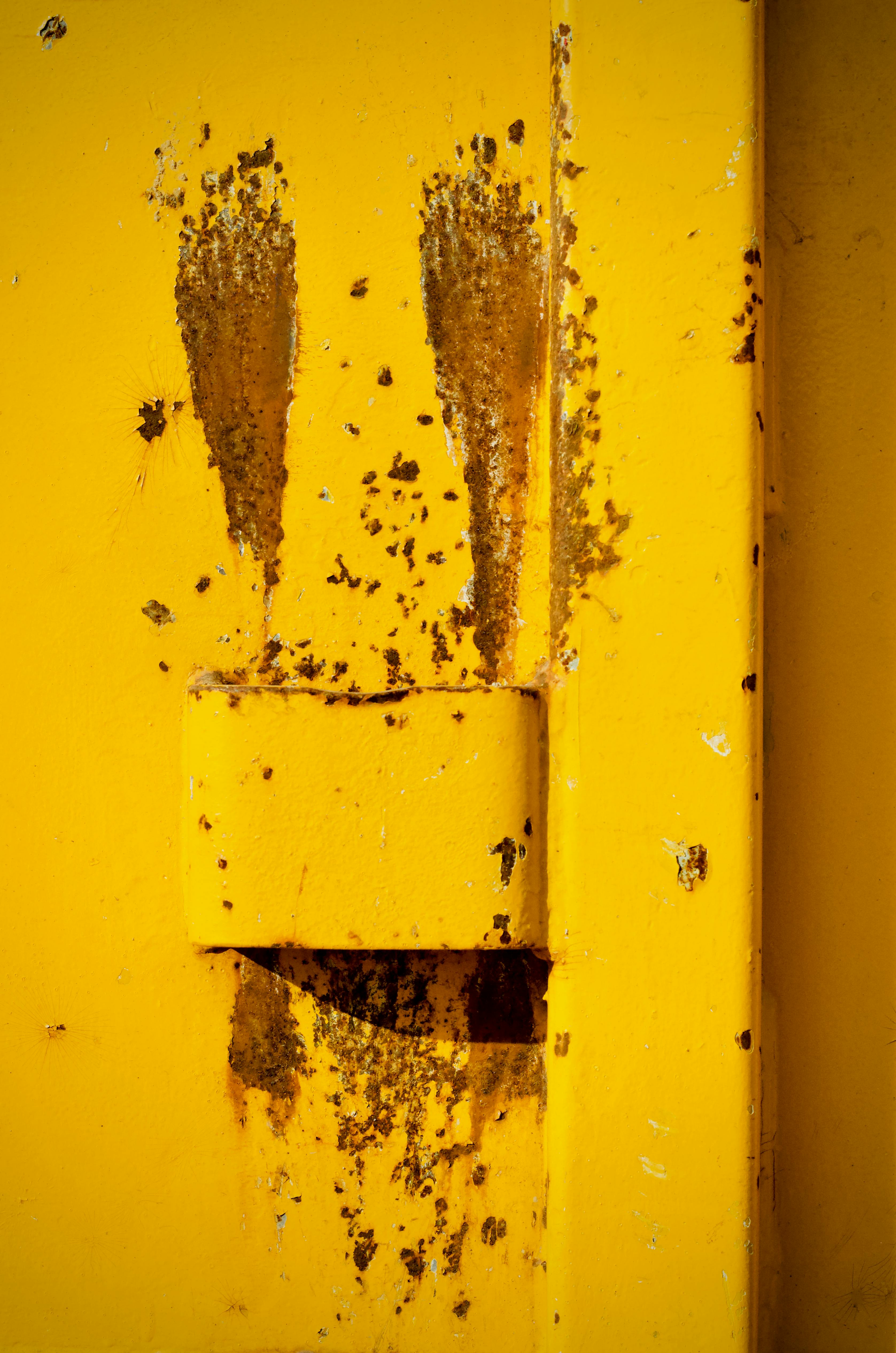 Free Close-up of rust stains on a yellow metal surface creating an abstract pattern. Stock Photo
