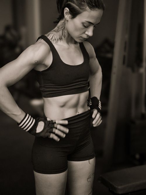 Free Confident female athlete showcasing strength in gym setting, wearing fitness attire. Stock Photo