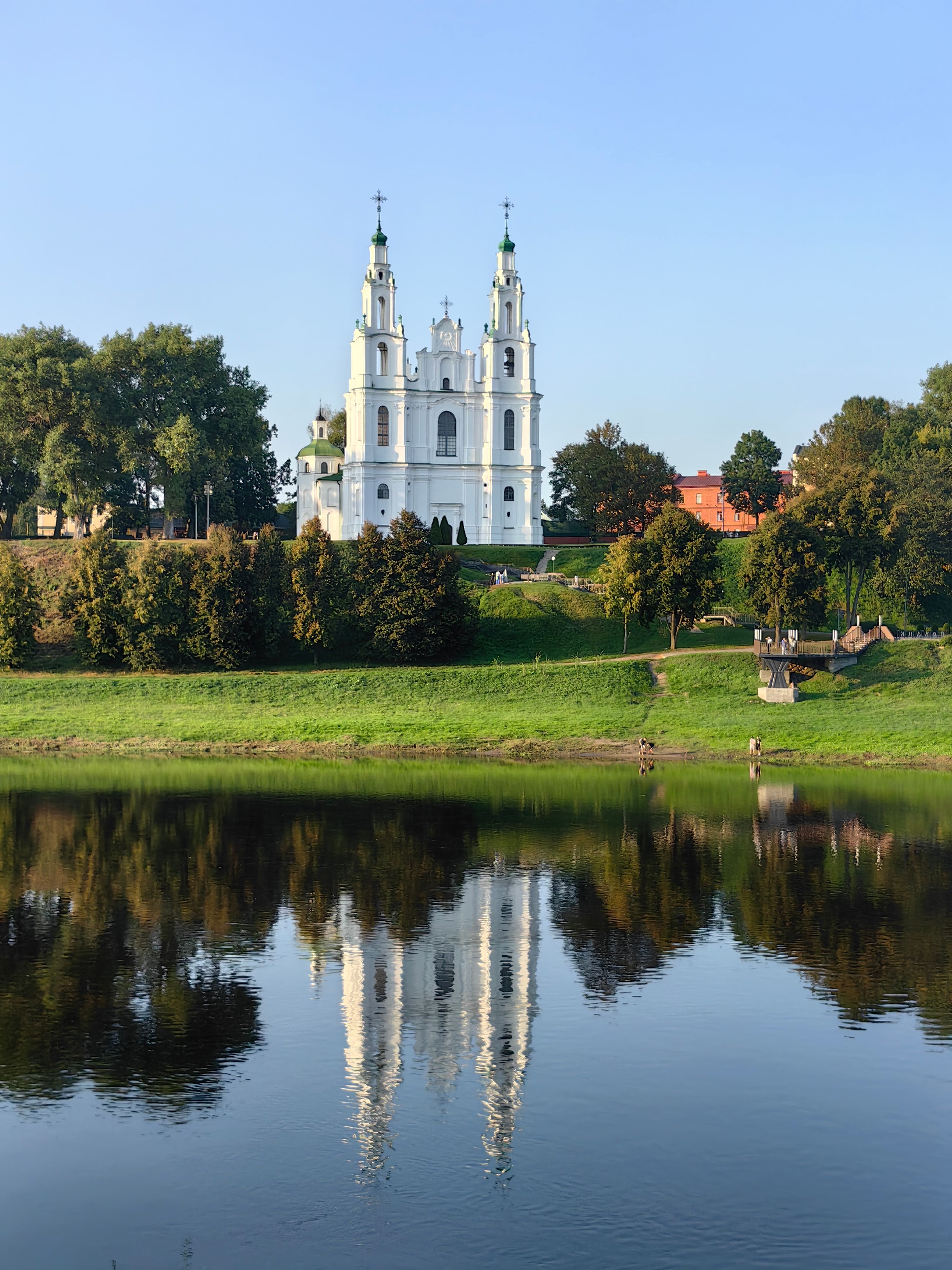 Beautiful reflection of the white Saint Sophia Cathedral on a calm river.