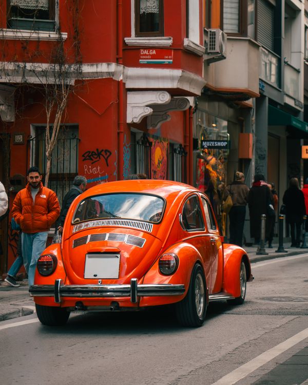 Classic Red Beetle Car on Urban Street · Free Stock Photo