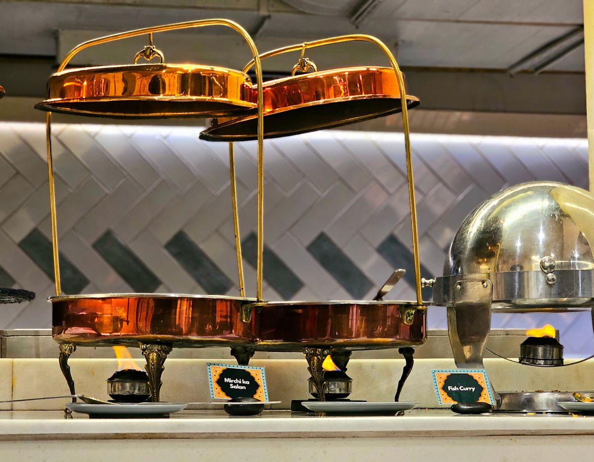 Copper buffet warmers arranged for a dinner event