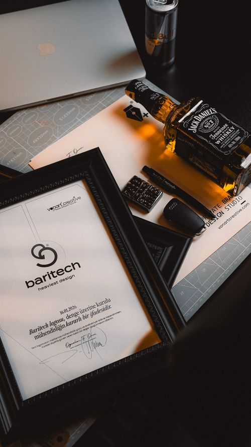 Free Stylish office desk with whiskey, documents, and design elements offering a moody atmosphere. Stock Photo