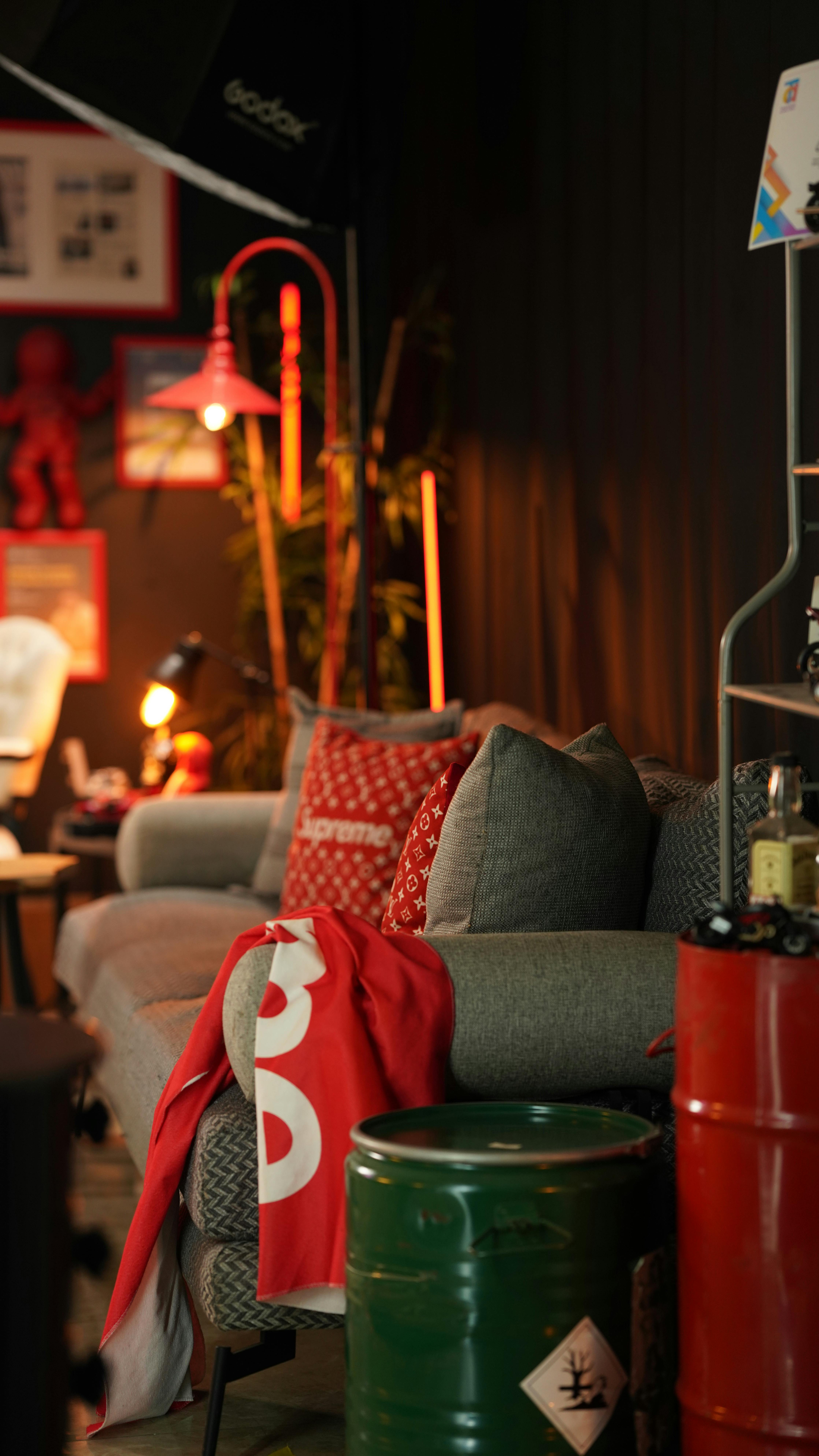 Free A stylish living room in Türkiye featuring an industrial design with a cozy sofa and vibrant red accents. Stock Photo
