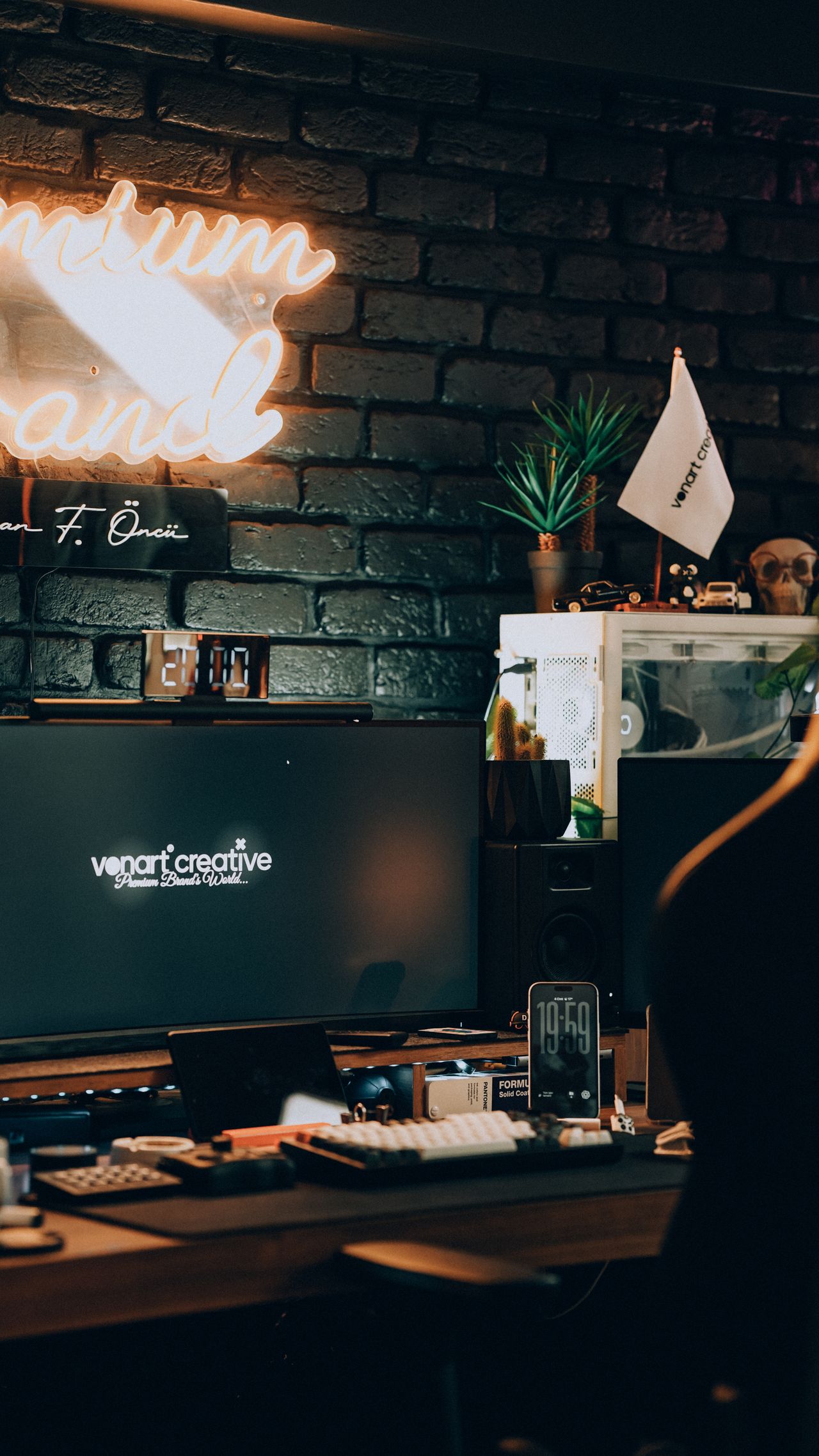 Stylish home office featuring neon lights, computer setup, and aesthetic decor