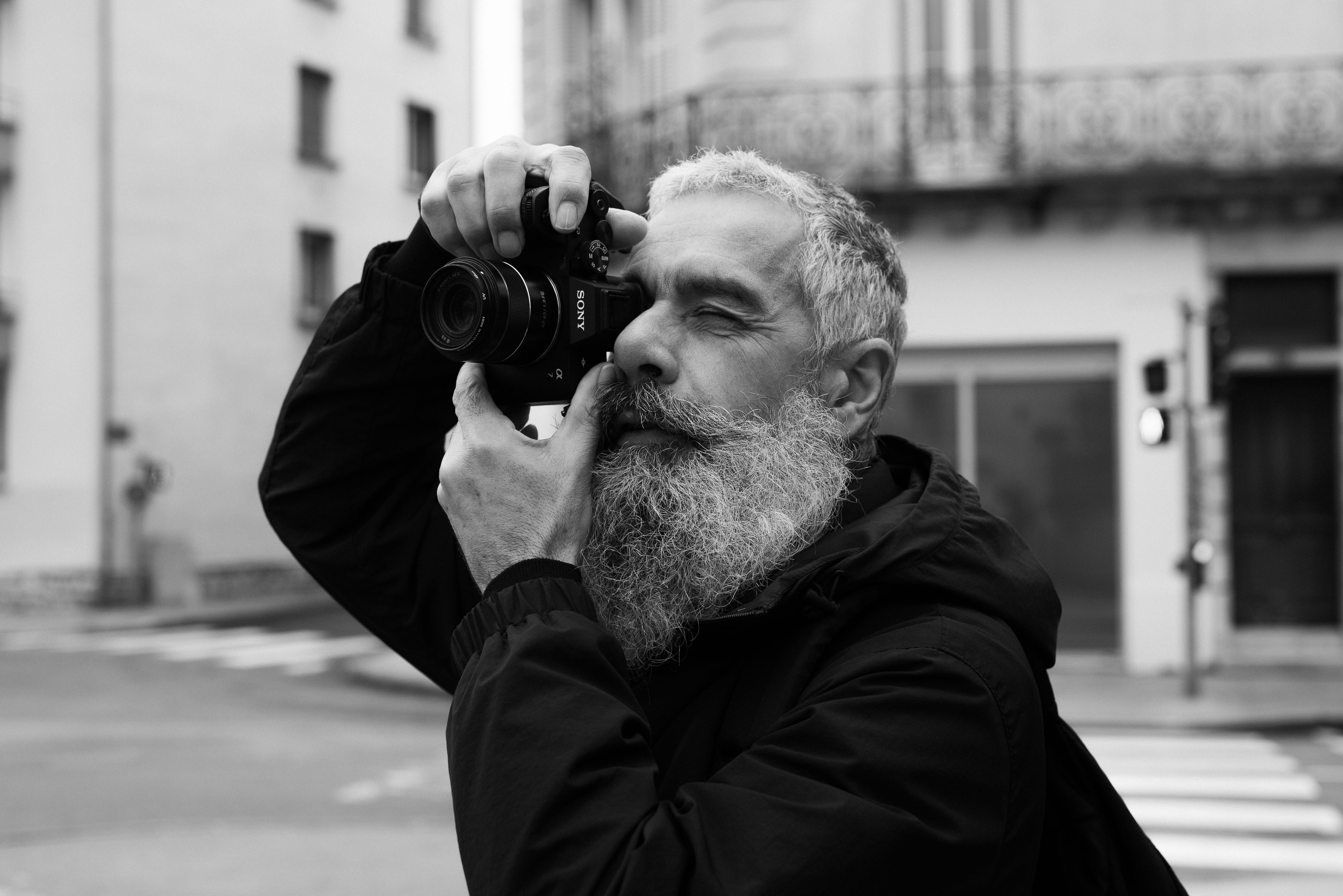 Elderly Photographer Shooting in Urban Street · Free Stock Photo