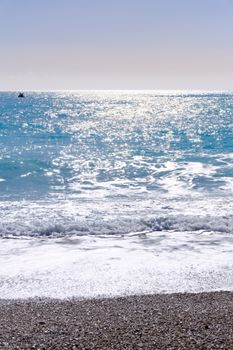 Relaxing seascape at Ölüdeniz beach with sparkling water under the sun.