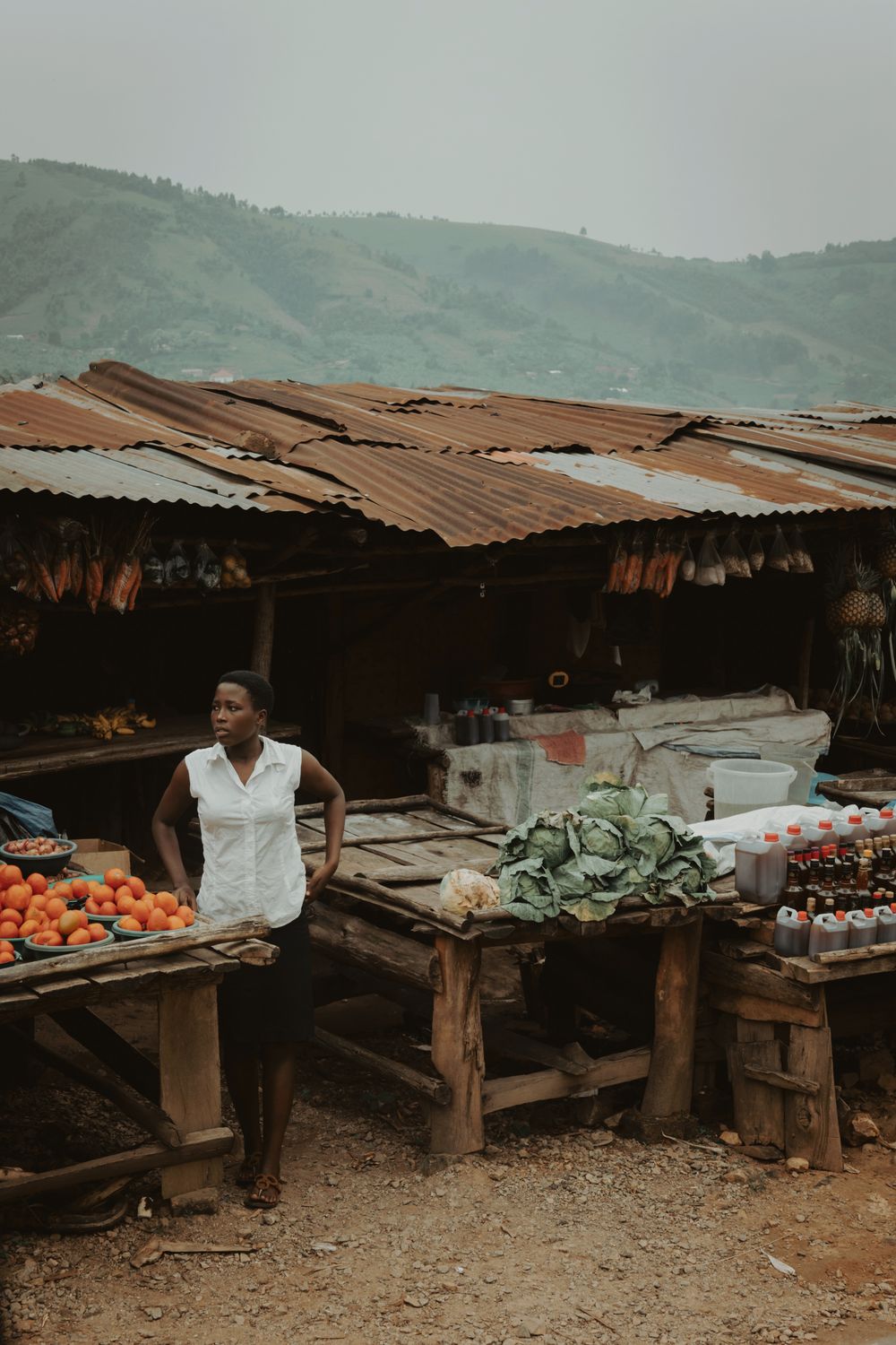 African woman selling fresh produce at an outdoor market