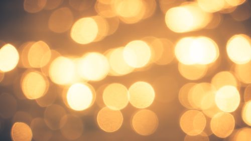 Free A soothing abstract image featuring golden bokeh lights creating a warm and festive atmosphere. Stock Photo