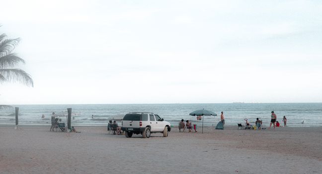 Tranquil beach setting with people enjoying their day by the ocean.