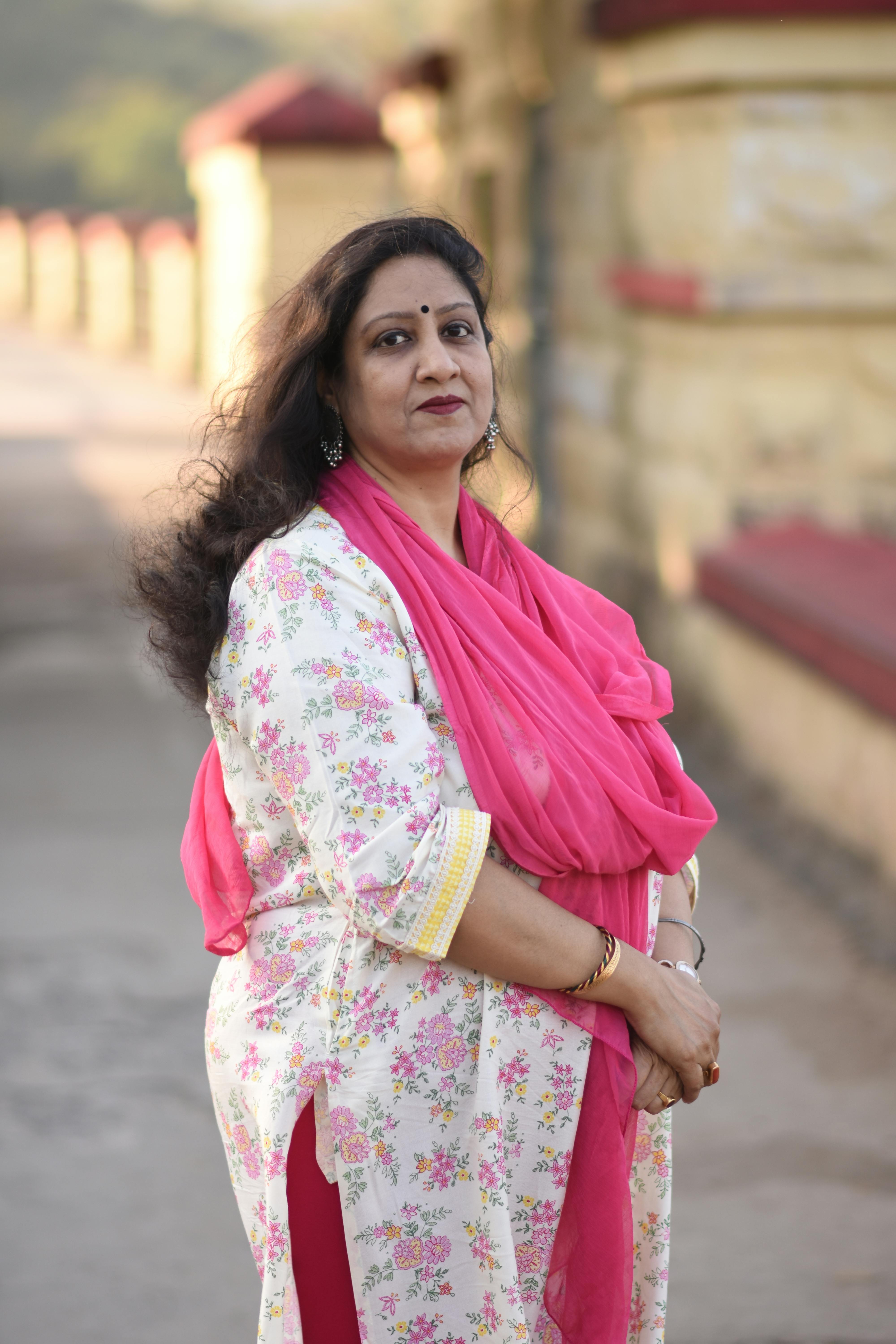 Portrait of an elegant woman in traditional Indian attire posing outdoors in Topchanchi, India.