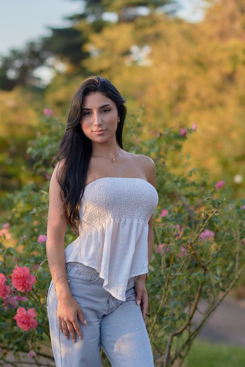 Woman in Garden During Golden Hour in Montevideo · Free Stock Photo