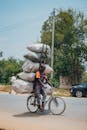 Man Balancing Heavy Load on Bicycle