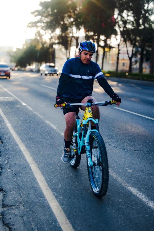 Free A cyclist wearing a helmet rides a bicycle on a city street in Guatemala. Stock Photo